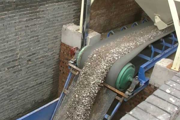 Tile and Bricks being crushed and transported on a conveyor belt