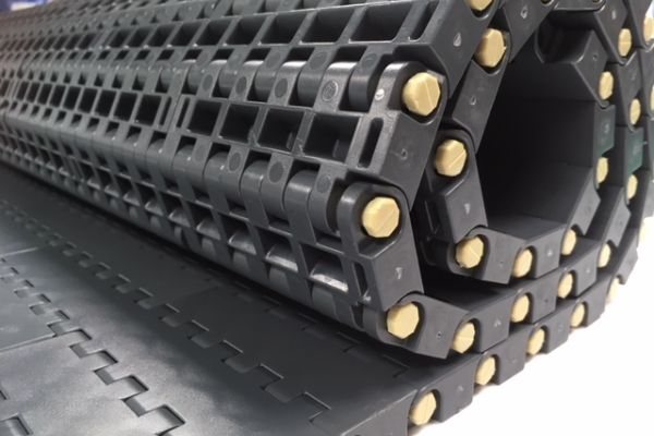 a black roll of plastic modular belting
